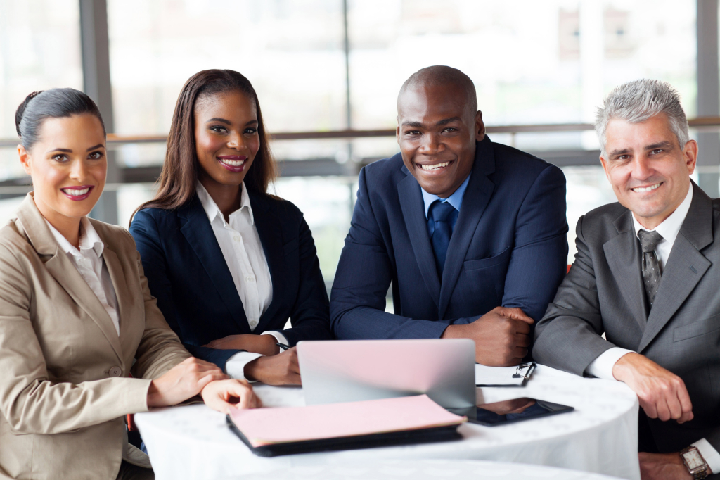 group of happy businesspeople sitting in office